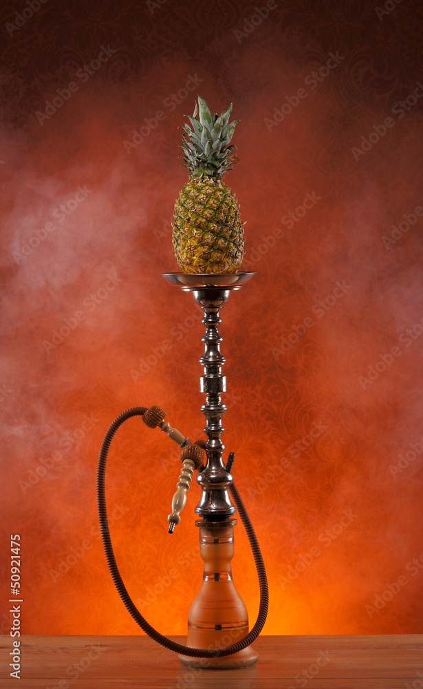 Exotic hookah with the fruit on the top over vintage background Exotic hookah with the fruit on the top over vintage background
