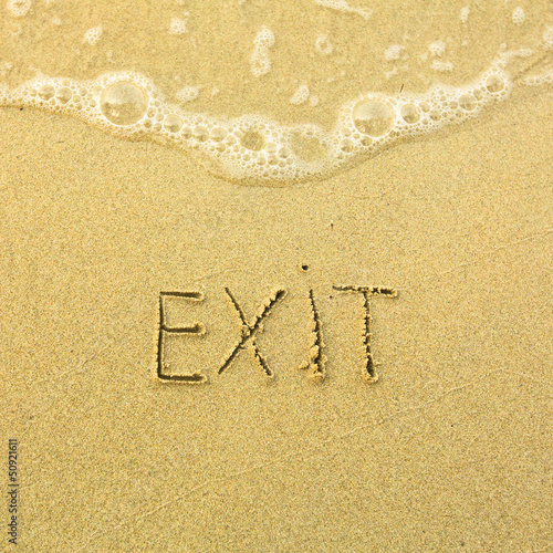 Exit - written in sand on beach texture © De Visu