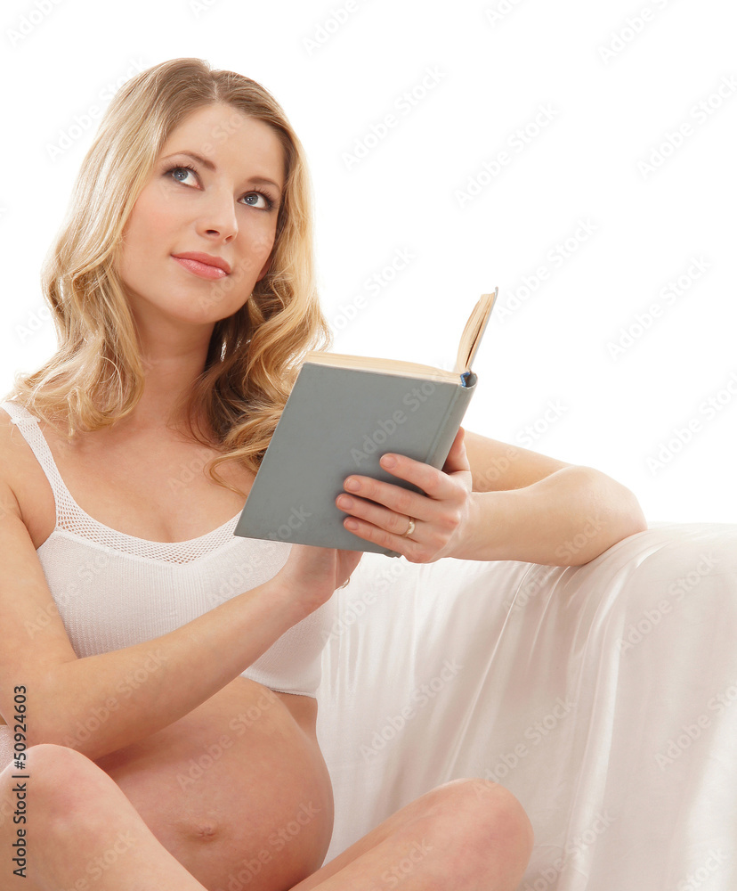 Happy pregnant woman holding a book isolated on white Happy pregnant woman holding a book isolated on white