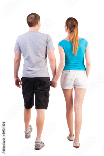 Back view of going young couple