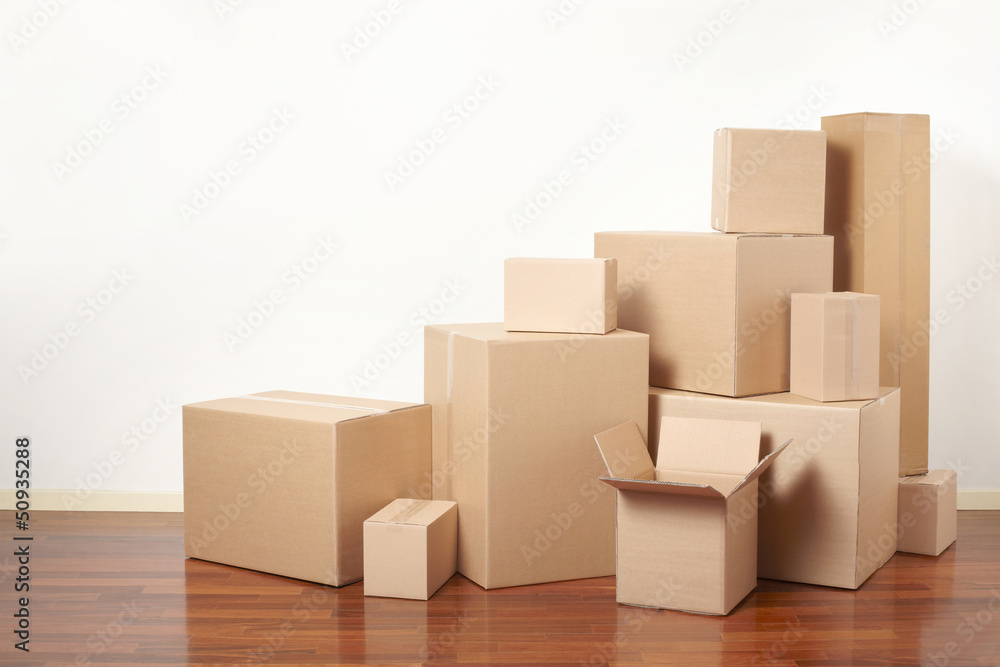 Cardboard boxes stack in apartment, moving day Cardboard boxes stack in apartment, moving day