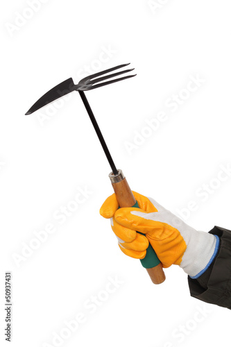 Gardening hoe and rake in human hand with gloves