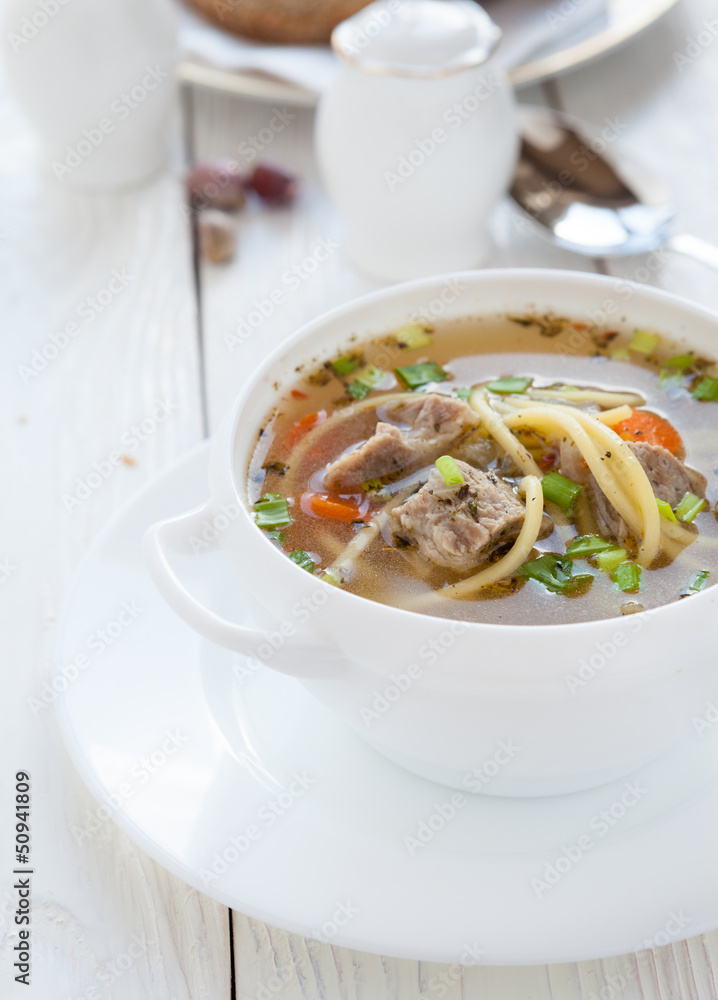 meat soup with vermicelli in a white tureen meat soup with vermicelli in a white tureen
