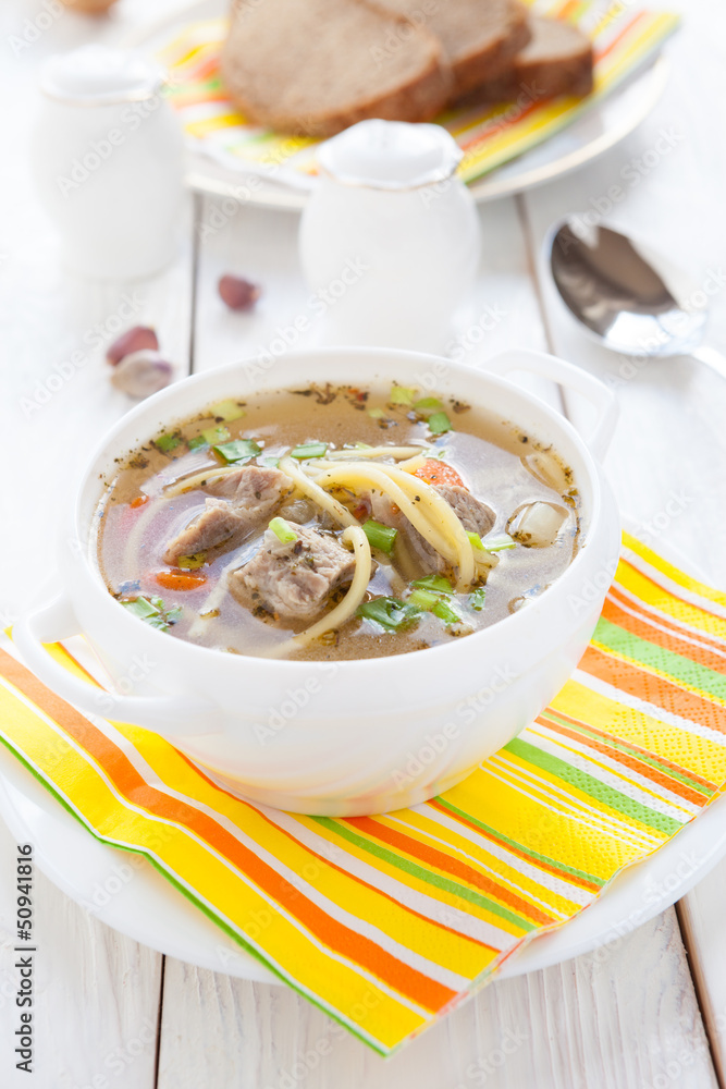 nourishing soup with vermicelli and beef in a white tureen nourishing soup with vermicelli and beef in a white tureen