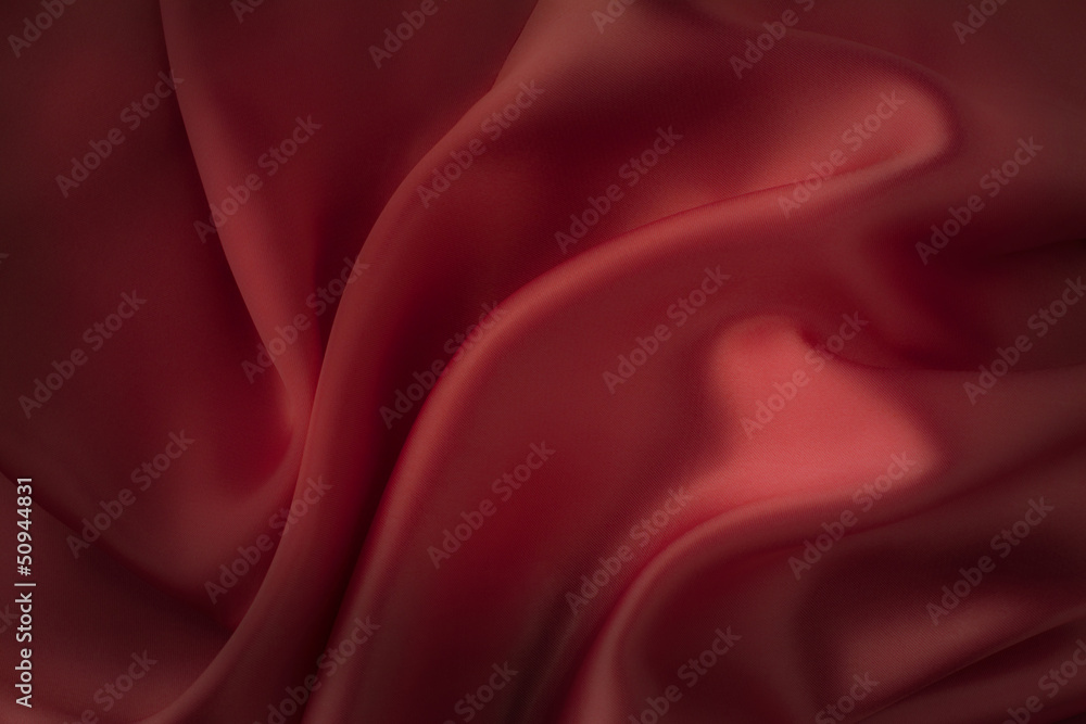 Fototapeta premium Dark red silk fabric background - soft, elegant and delicate