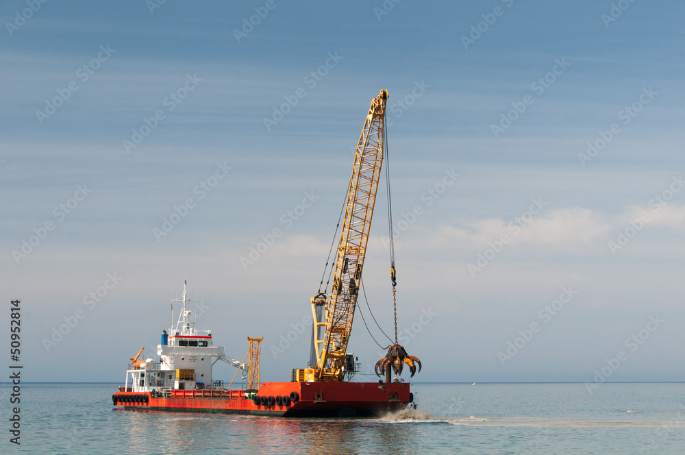 Fototapeta premium Dredger lifts Mud from Harbor