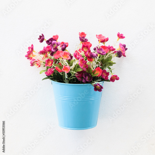 Colorful flowerpot on  the white wall