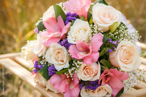 bouquet of the bride executed from light pink and beige roses