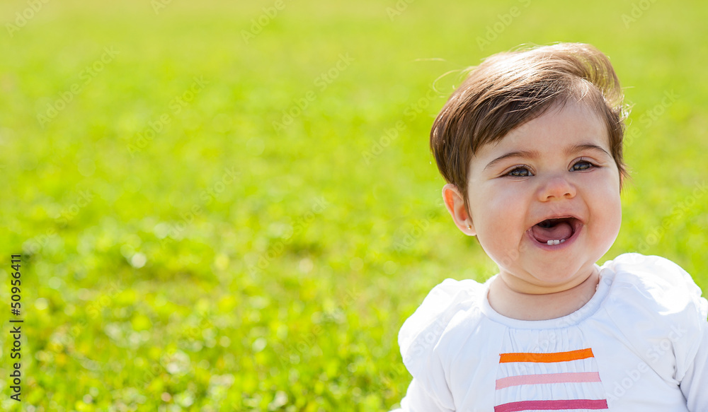 Close up portrait of a smiling baby with green background Close up portrait of a smiling baby with green background
