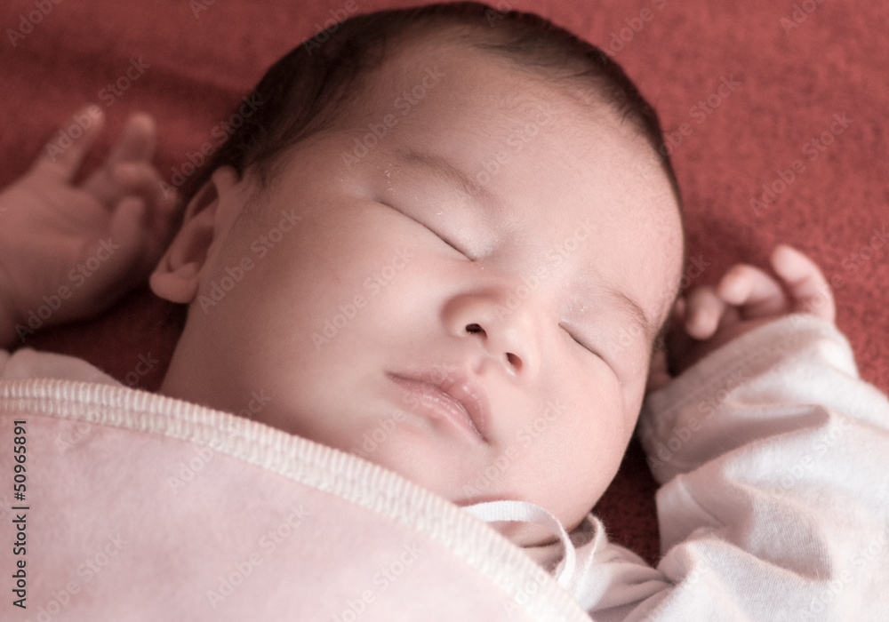 Newborn baby sleeping on the bed, selective focus Newborn baby sleeping on the bed, selective focus