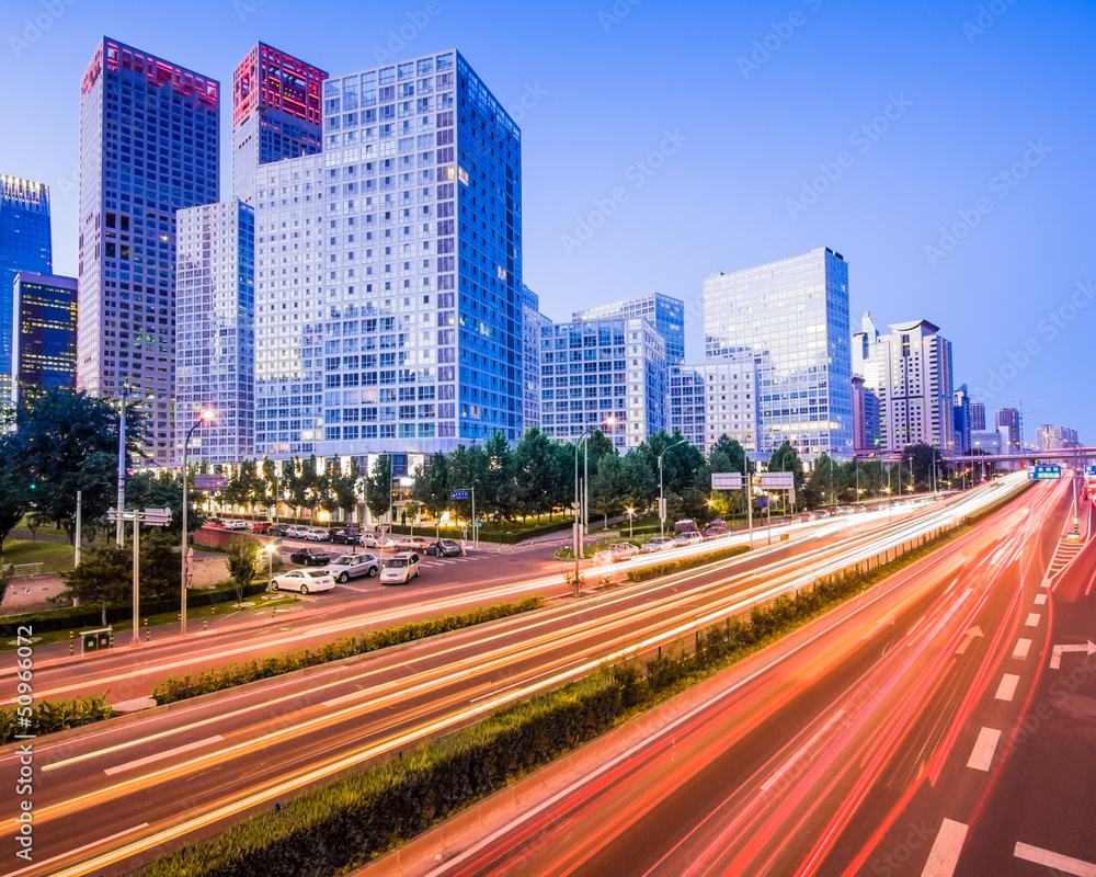 Obraz premium light trails on the modern city at dusk in beijing,China