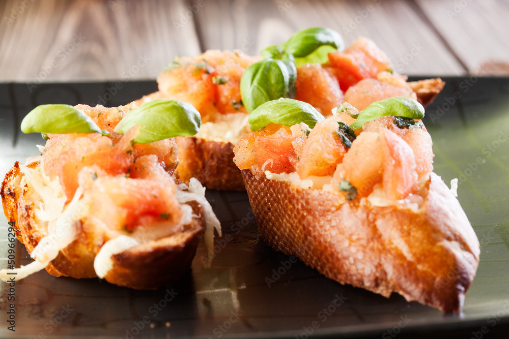 Bruschetta with mozzarella and tomato. Selective focus Bruschetta with mozzarella and tomato. Selective focus