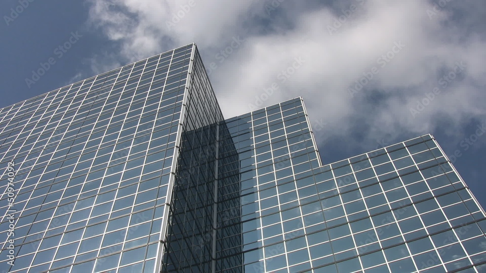 Blue office building with clouds moving past. Real time. Blue office building with clouds moving past. Real time.