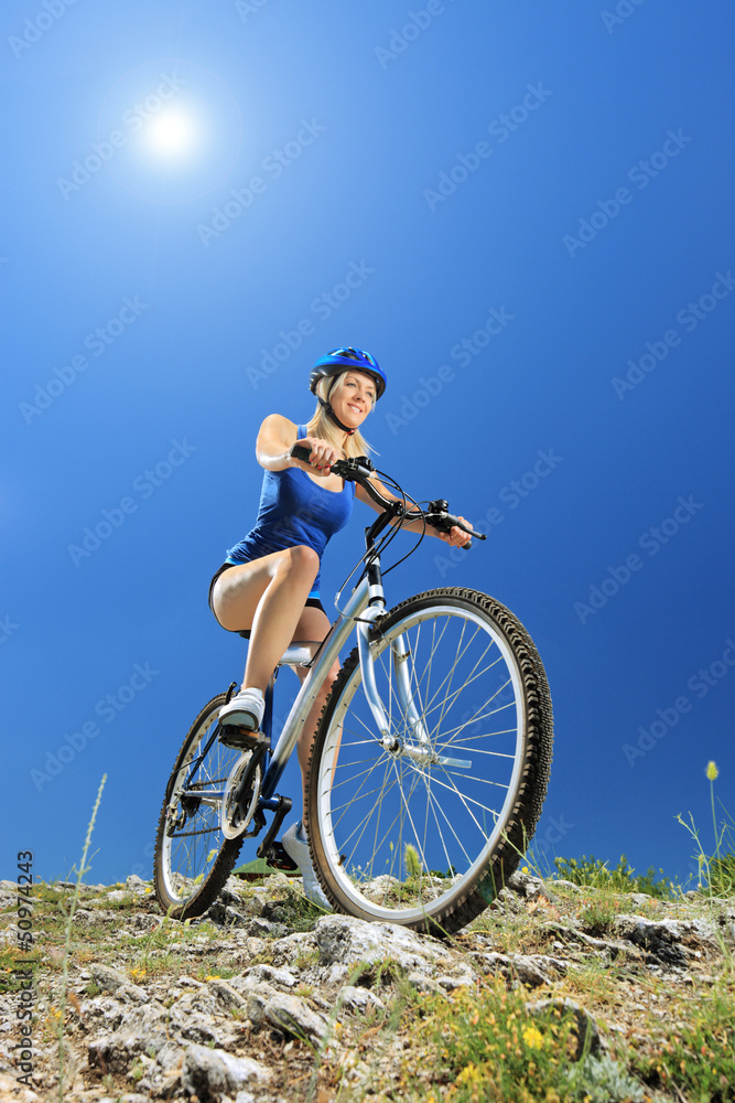 A female biker riding a mountain bike A female biker riding a mountain bike