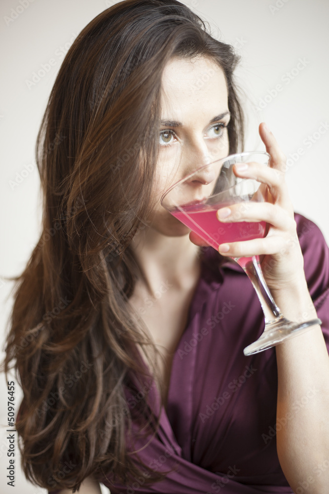 Beautiful Young Woman Holding a Pink Martini Beautiful Young Woman Holding a Pink Martini