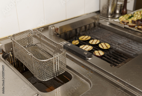 Deep fryer and grill on commercial kitchen