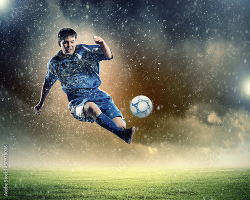 football player striking the ball © Sergey Nivens