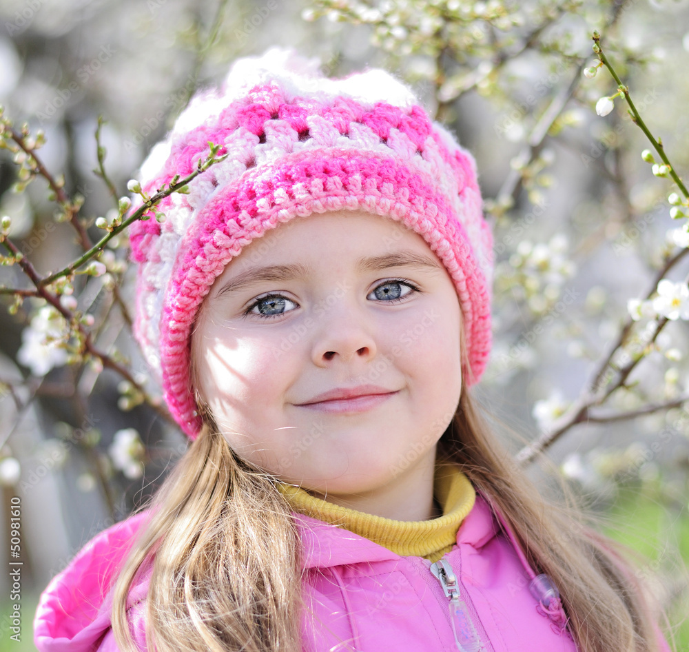 beautiful little girl near a flowering tree beautiful little girl near a flowering tree