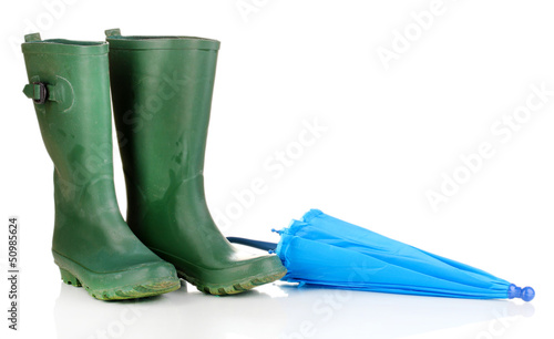 green gumboots and umbrella isolated on white photo