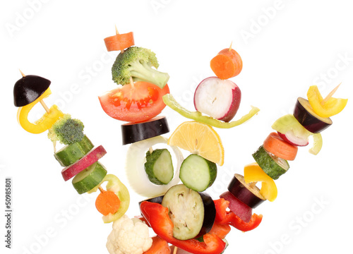 Sliced vegetables on wooden picks isolated on white