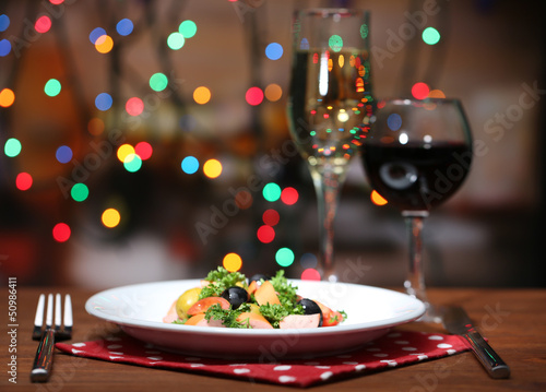 Tasty salad on dark background with bokeh  defocused lights