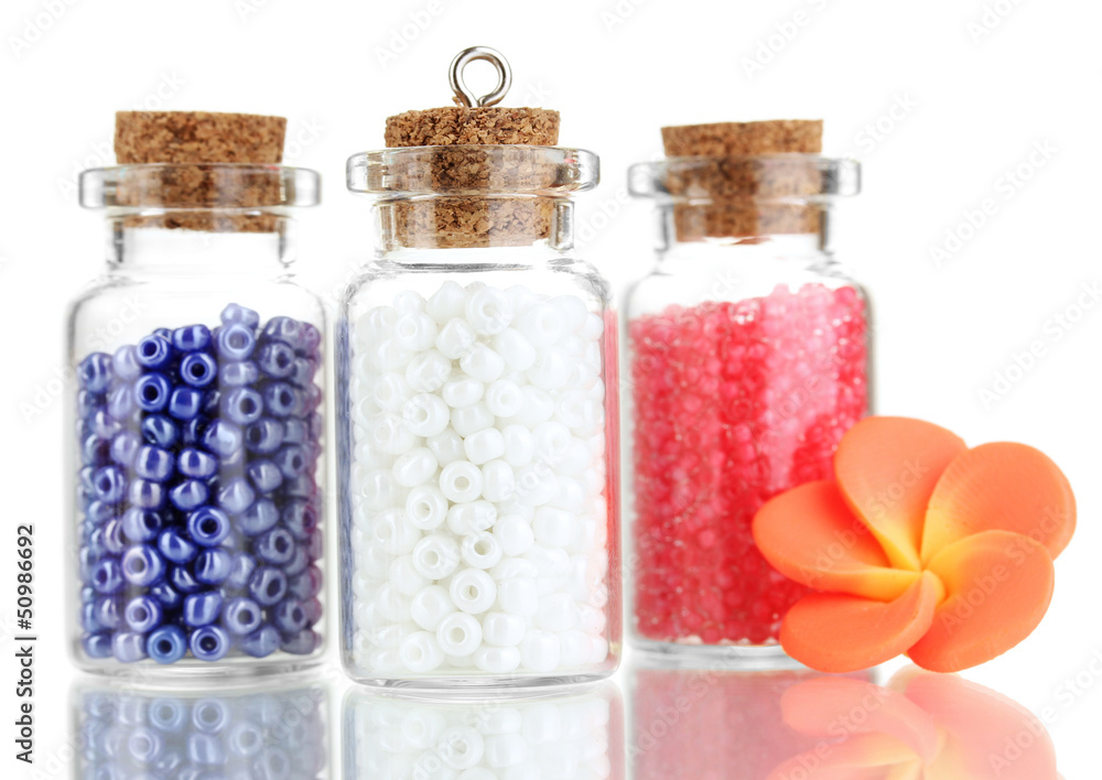 Little bottles full with colorful beads isolated on white Little bottles full with colorful beads isolated on white