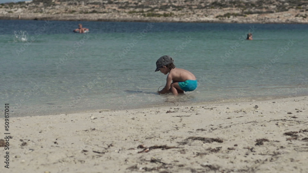 Cute kid playing on the beach, super slow motion Cute kid playing on the beach, super slow motion