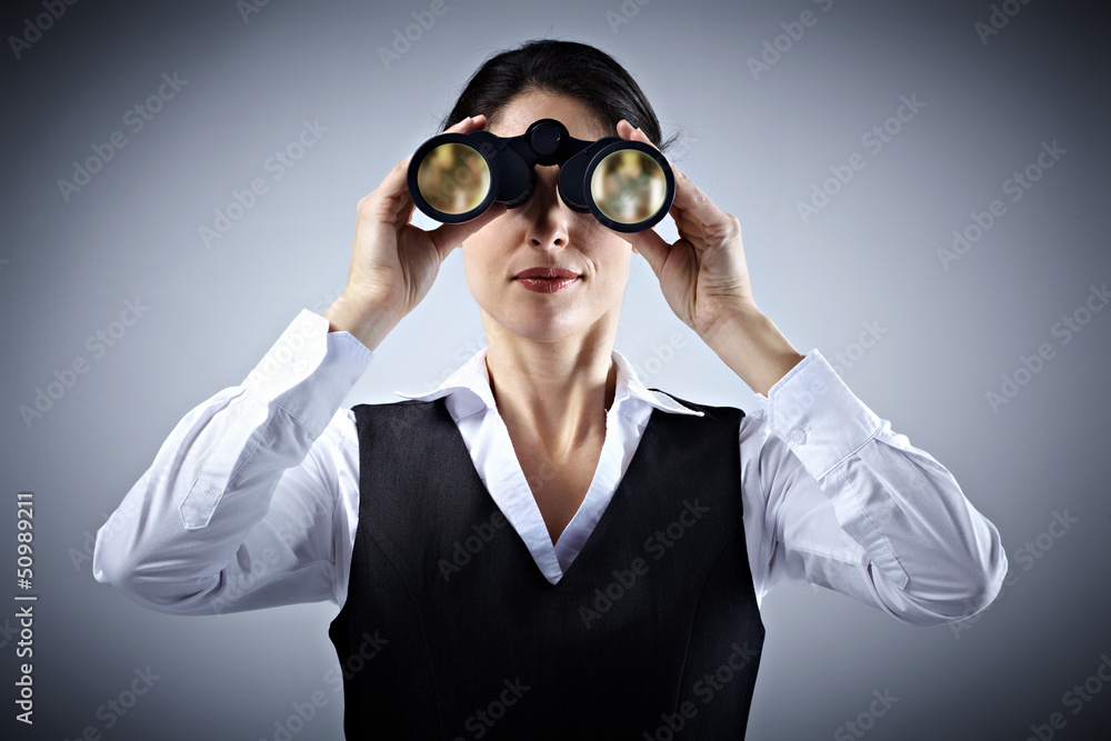 Business woman with binoculars. Business woman with binoculars.
