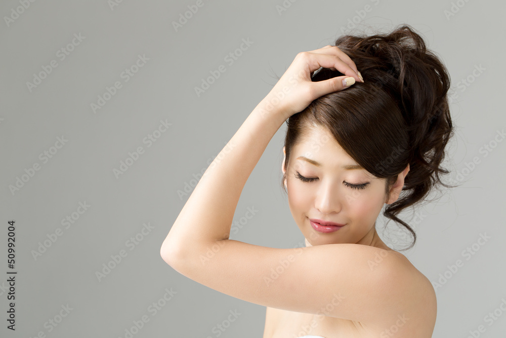 Beautiful young woman isolated on gray Beautiful young woman isolated on gray