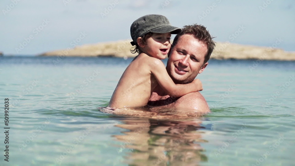 Father and son playing in the sea Father and son playing in the sea