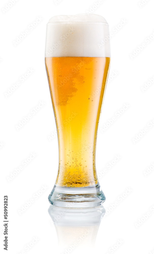 Glass of fresh beer with cap of foam isolated on a white backgro