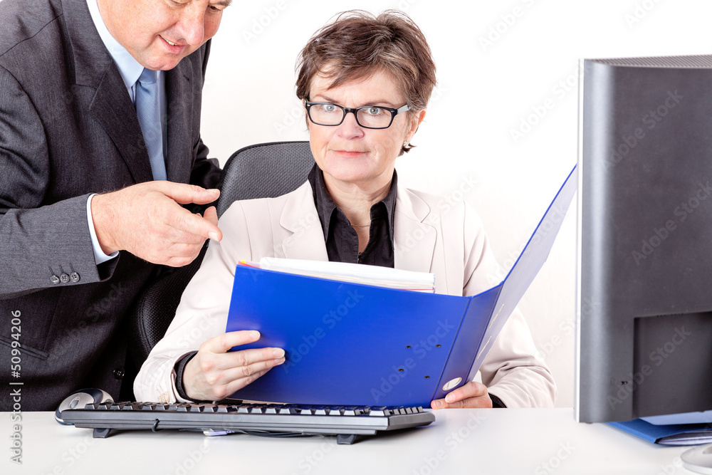 Chief looks together with staff in file folders Chief looks together with staff in file folders