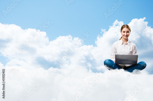 young girl running in the clouds with a laptop