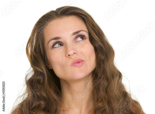 Portrait of interested young woman looking on copy space