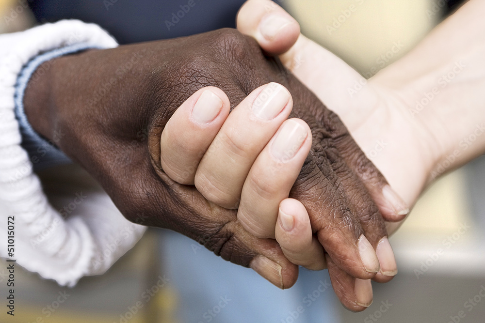 Fototapeta premium Old african-american holding hands with caucasian young person