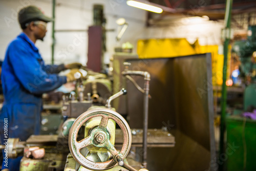 Fotografie An industrial service repairmen labouring in workshop