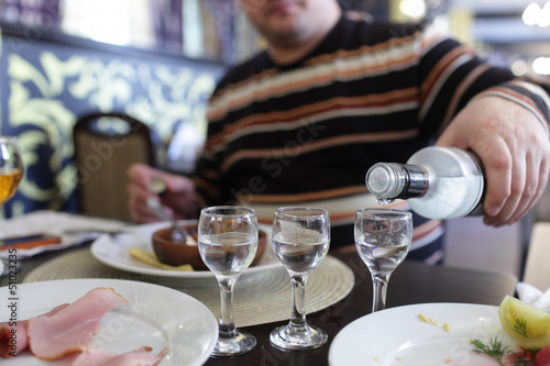 Man buttles vodka in a taverna