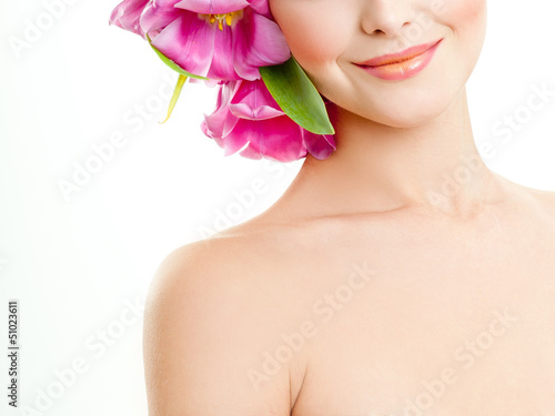 model with large hairstyle and flowers in her hair.