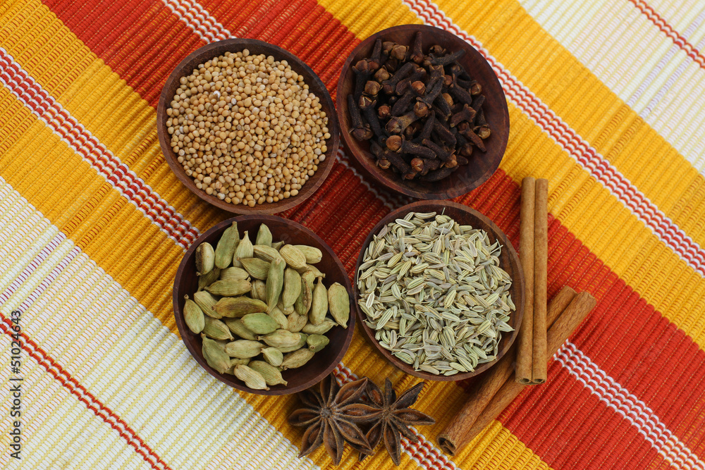 Mixed spices in small wooden bowls on striped background Mixed spices in small wooden bowls on striped background