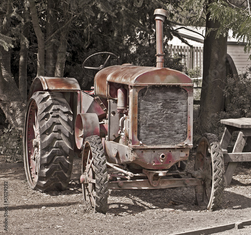 Old rusty red vintage tractor