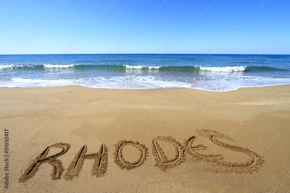Fototapeta premium Rhodes written on sandy beach