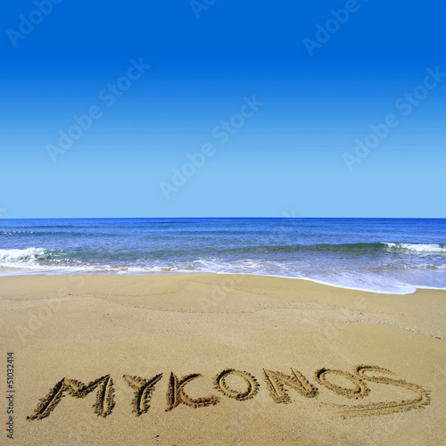 Mykonos written on sandy beach
