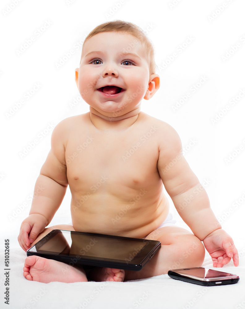cheerful baby plays with tablet PC and mobile phone cheerful baby plays with tablet PC and mobile phone