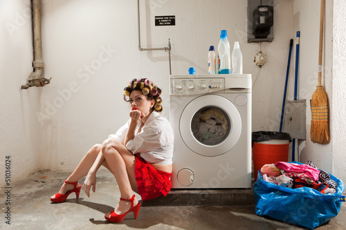 Fotografija housewife bored in the laundry