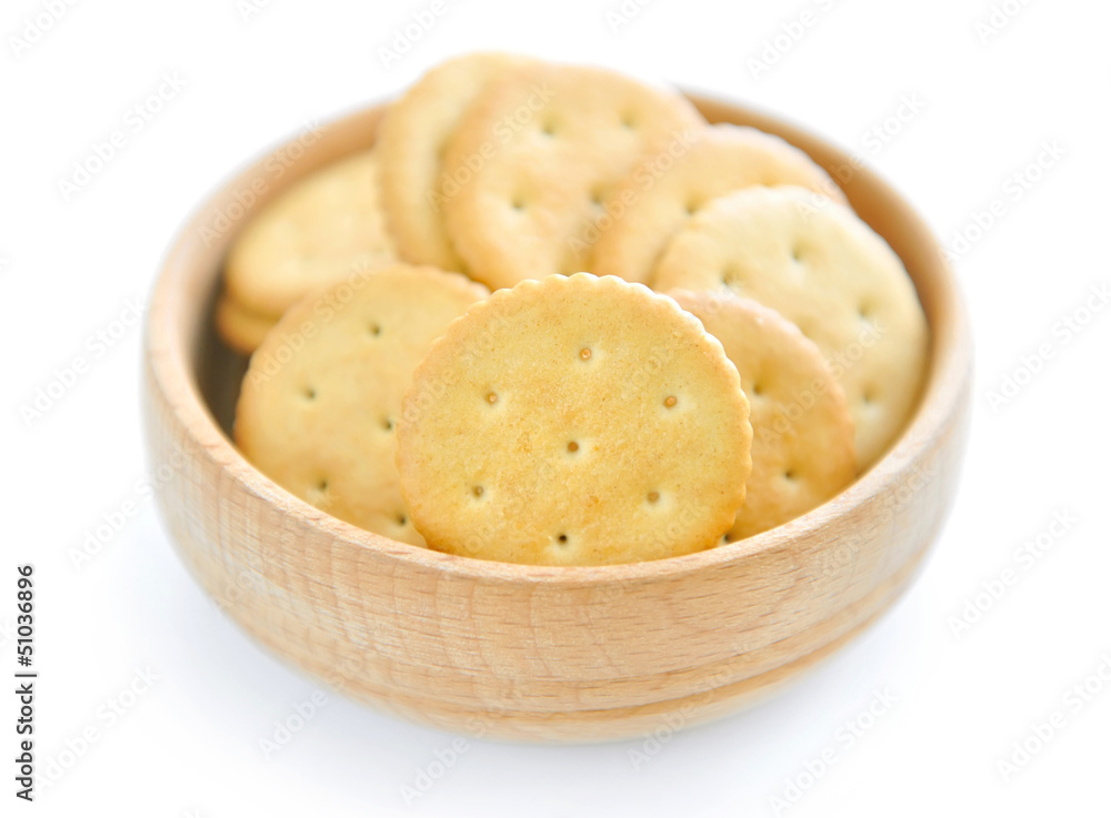Crackers in a wooden bowl on white background Crackers in a wooden bowl on white background