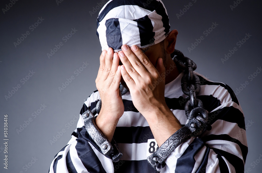 Convict criminal in striped uniform