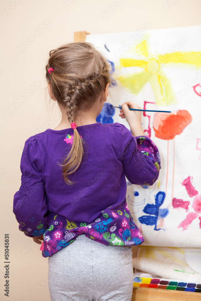 Rear view of painting with brush Caucasian preschool girl Rear view of painting with brush Caucasian preschool girl