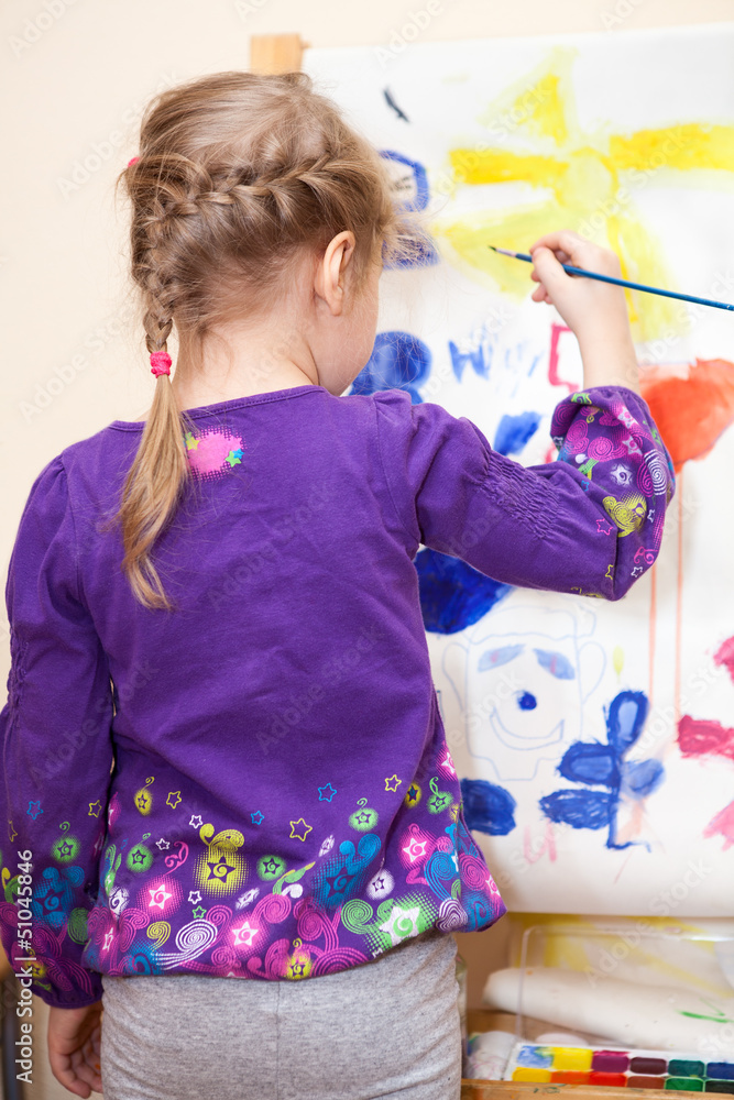 Small Caucasian child painting with brush and paint Small Caucasian child painting with brush and paint