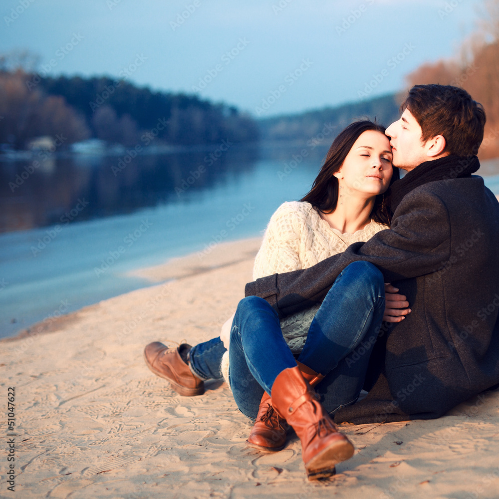 Young attractive couple in love posing in cold spring
