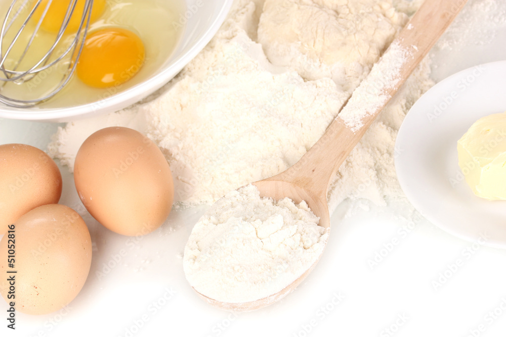 Eggs, flour and butter close-up isolated on white Eggs, flour and butter close-up isolated on white